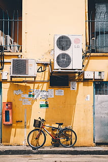 red and black bike beside yellow wall, sidewalk, roadside, path HD wallpaper