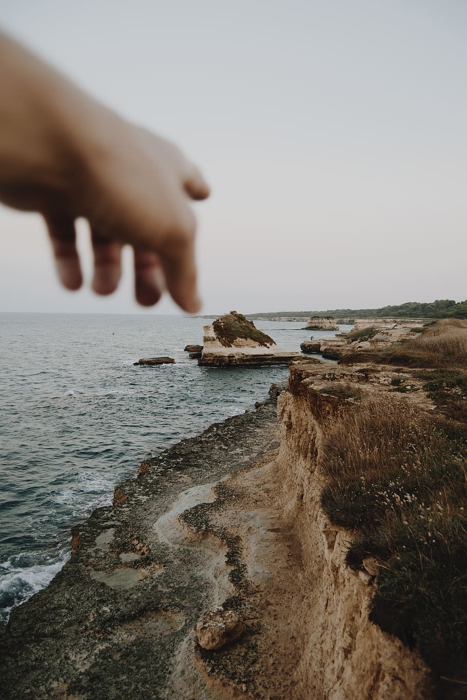 person pointing seashore, cliff, outdoors, nature, human, promontory HD wallpaper