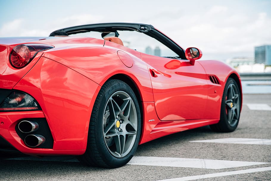 Red convertible sports car with alloy wheels and chrome silencer HD wallpaper