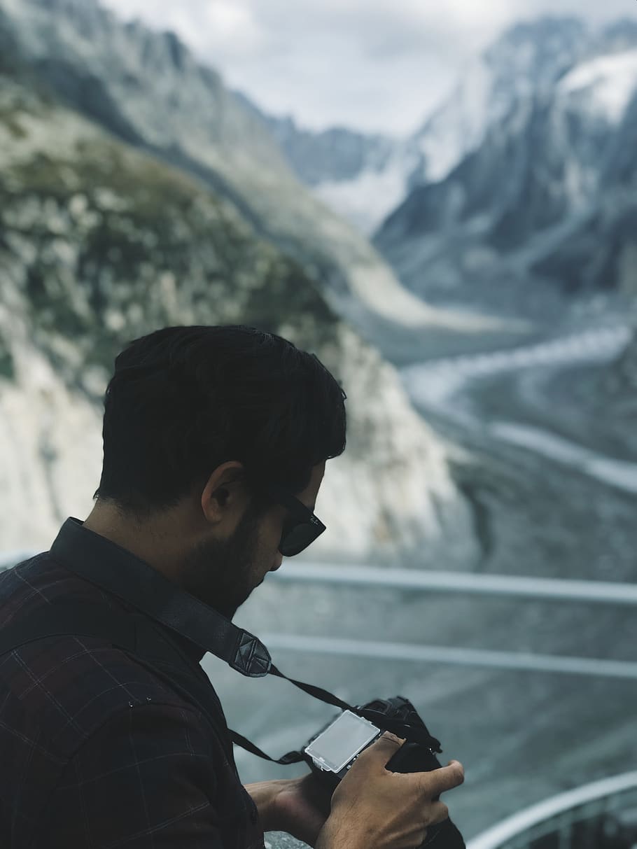 man checking his camera, person, human, nature, outdoors, mountain HD wallpaper
