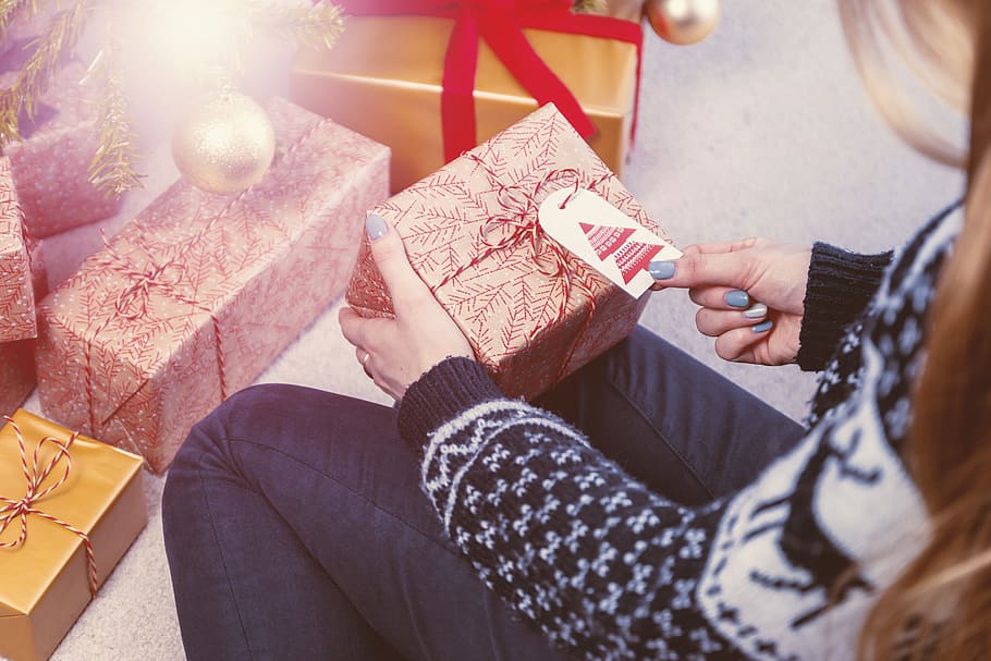 Close-up of female hands unpacking a present. Merry Christmas HD wallpaper