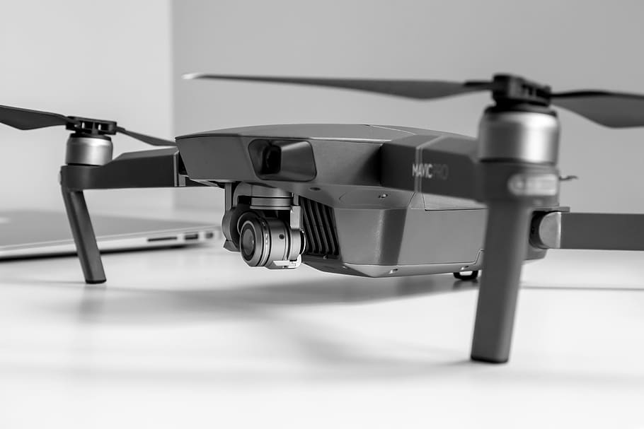 New drone with camera for filming on the table at office, indoors HD wallpaper