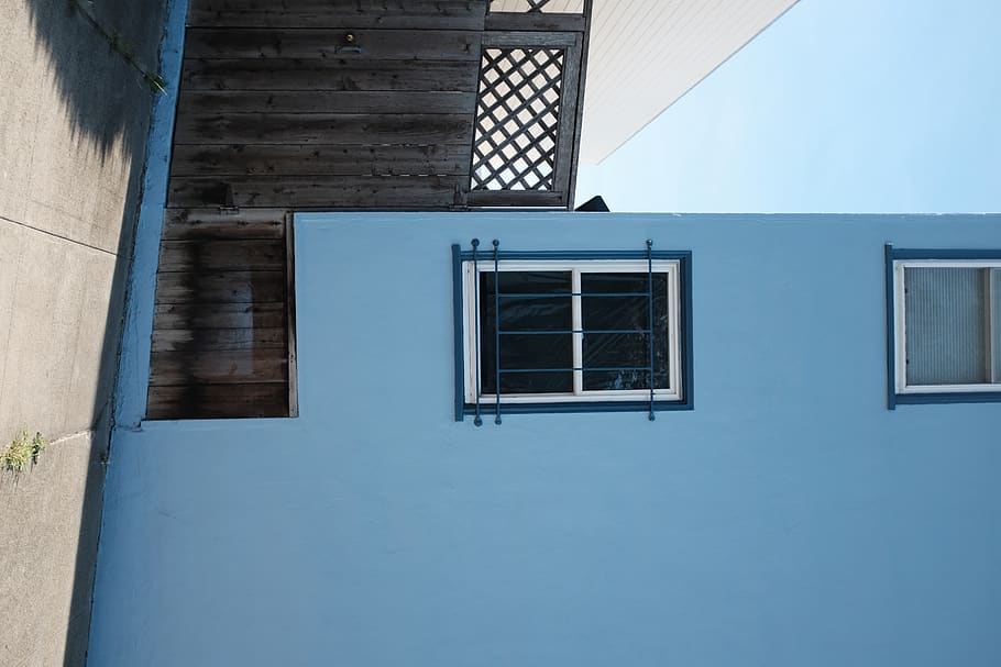blue painted building with white framed glass window, home decor