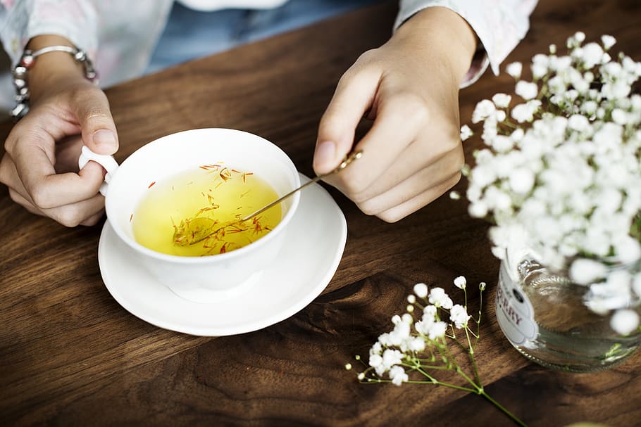 Person Holding Silver Spoon on White Ceramic Teacup With Yellow Liquid Inside, HD wallpaper