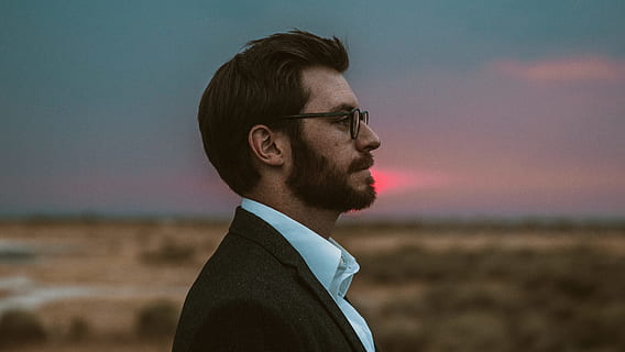 man in black formal suit wearing eyeglasses, side profile, face HD wallpaper