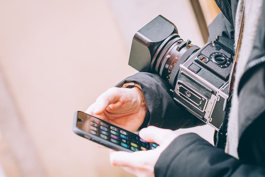 person using iPhone and holding camera, mobile phone, electronics HD wallpaper