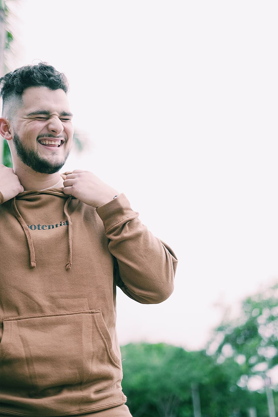 men's brown pullover hoodie, smiling, happiness, one person, standing HD wallpaper