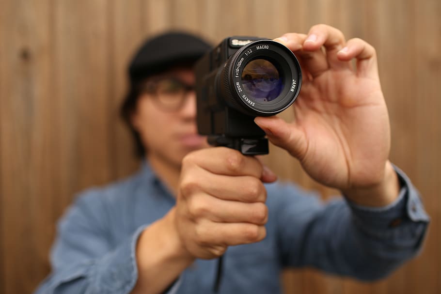 person using camera gun, human, electronics, photographer, finger HD wallpaper