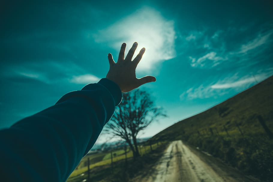 Person Raising Hand Towards Blue Sky during Daytime, clouds, grass HD wallpaper