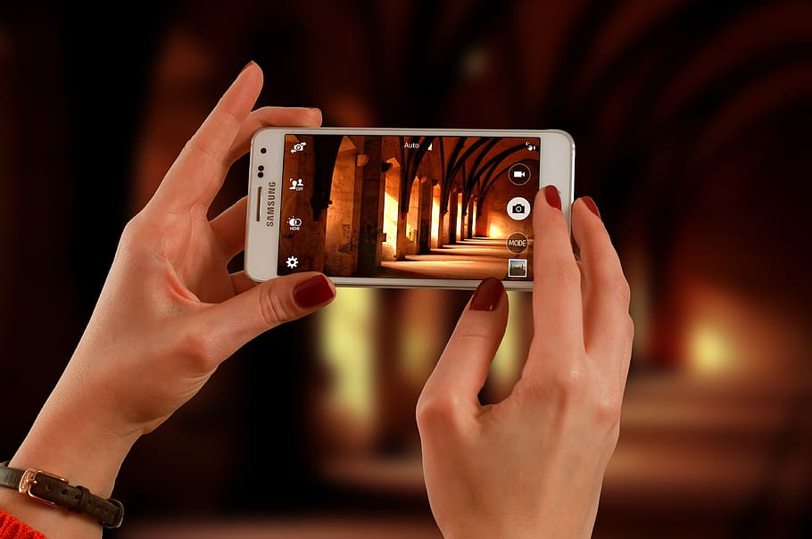 Woman Holding a White Samsung Galaxy Android Smartphone Taking a Photo of Hallway HD wallpaper