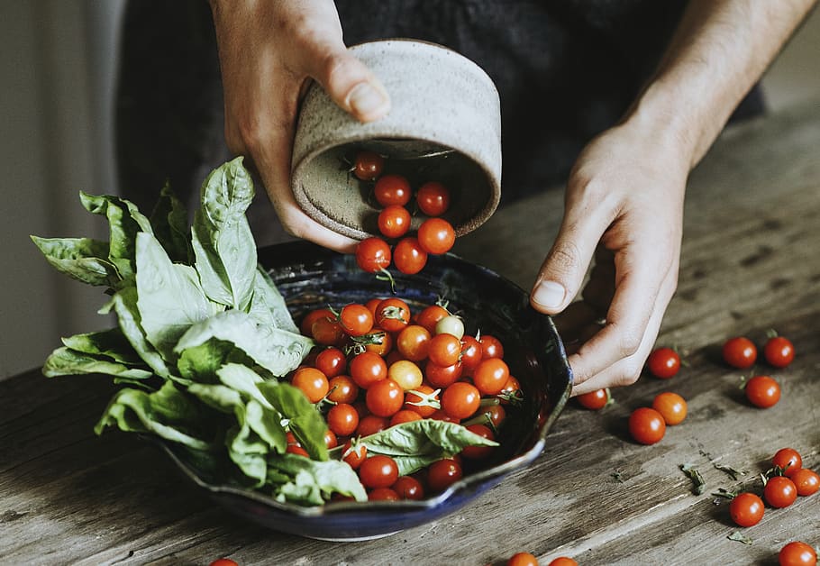 Person Putting Tomatoes on Bowl, adding, cherry tomatoes, close-up HD wallpaper