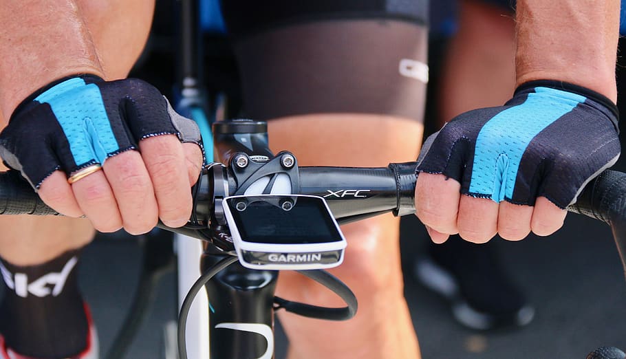 close-up photo of cyclist's hands on road bike handle bar, person