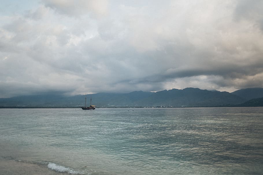 Black Boat on Body of Water, calm, clouds, dawn, mountain, ocean HD wallpaper