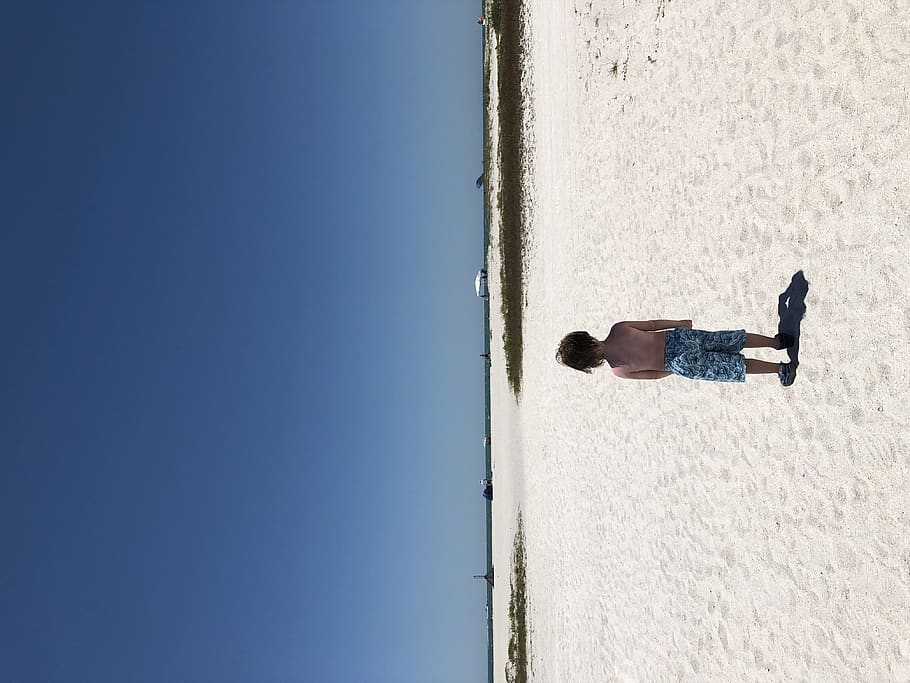 beach, boy, sea, wind, sky, day, one person, blue, nature, real people HD wallpaper