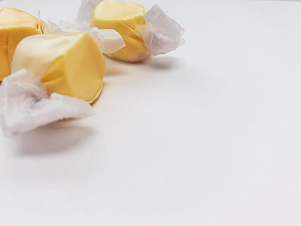 candy, taffy, sweet, sweets, yellow, white space, snack, food HD wallpaper