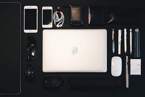 silver MacBook between Magic Mouse, pencil, sunglasses, and iPhone HD wallpaper