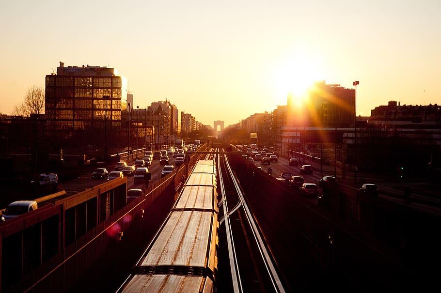 sunset, sky, buildings, train tracks, railroad, cars, trucks HD wallpaper