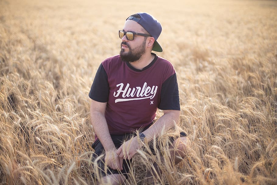 man, sitting, field, sunglasses, people, hat, cap, baseball cap HD wallpaper