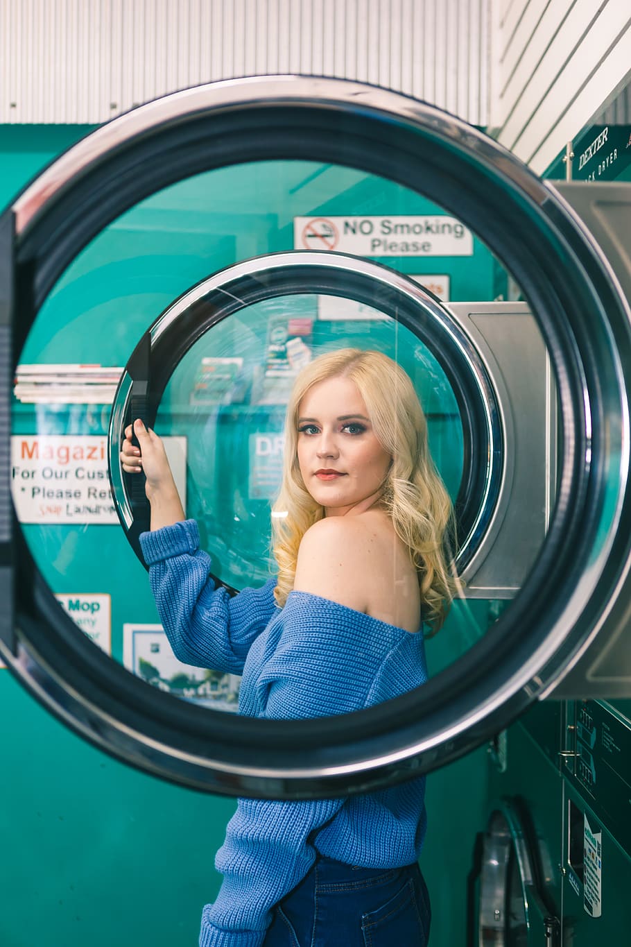 Woman in Blue Off-shoulder Long-sleeved Shirt Standing Beside Washing Machine