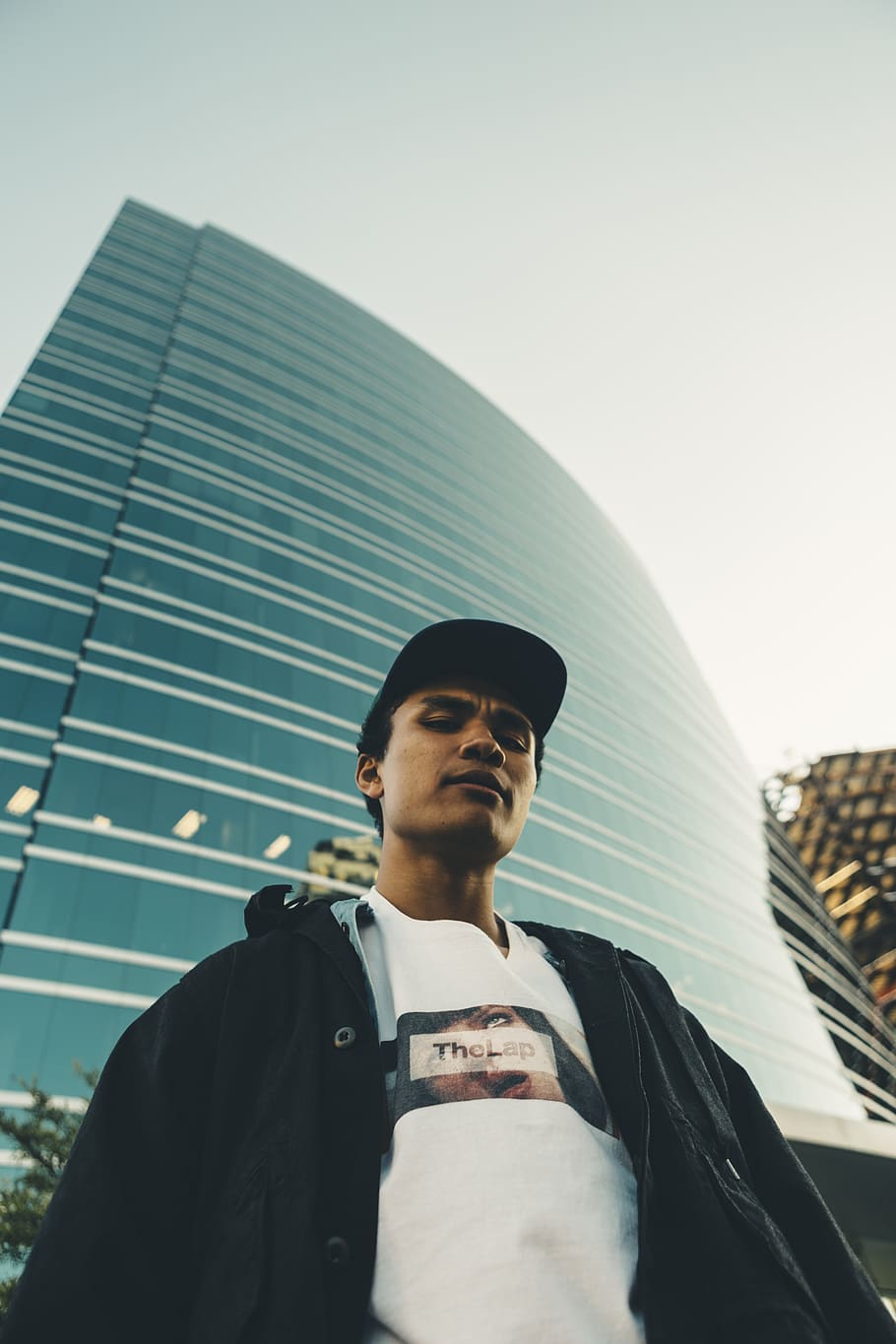 man standing beside high-rise building, real people, lifestyles HD wallpaper