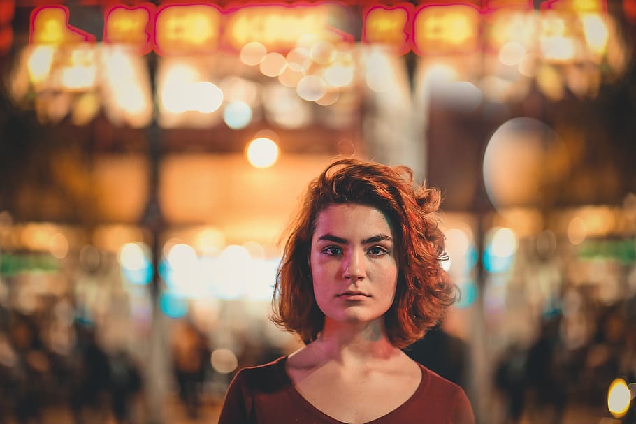 selective focus photography of woman with short hair wearing red scoop-neck top
