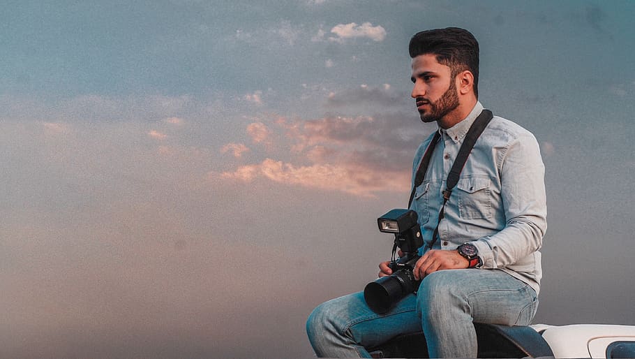 man sitting while holding DSLR camera, person, human, people HD wallpaper