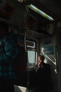 man sitting while holding phone, human, person, transportation HD wallpaper