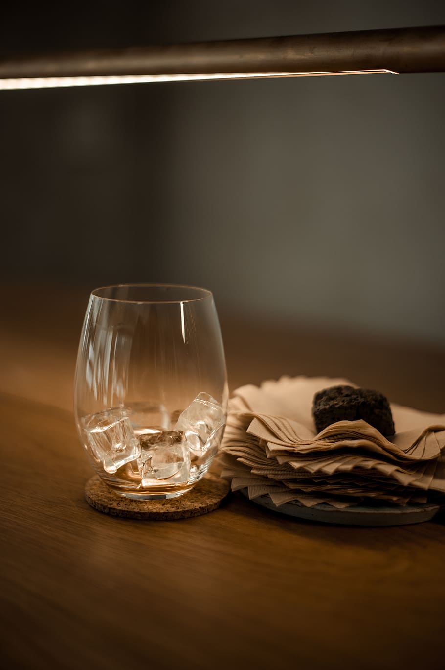 clear drinking glass beside paper, goblet, beverage, light, iced