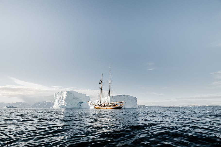 boat on calm body of water near ice bergs, vehicle, transportation