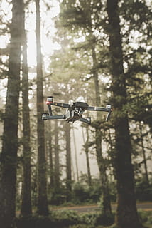 gray and black DJI Mavic Pro quadcopter drone on mid top air near forest at daytime HD wallpaper