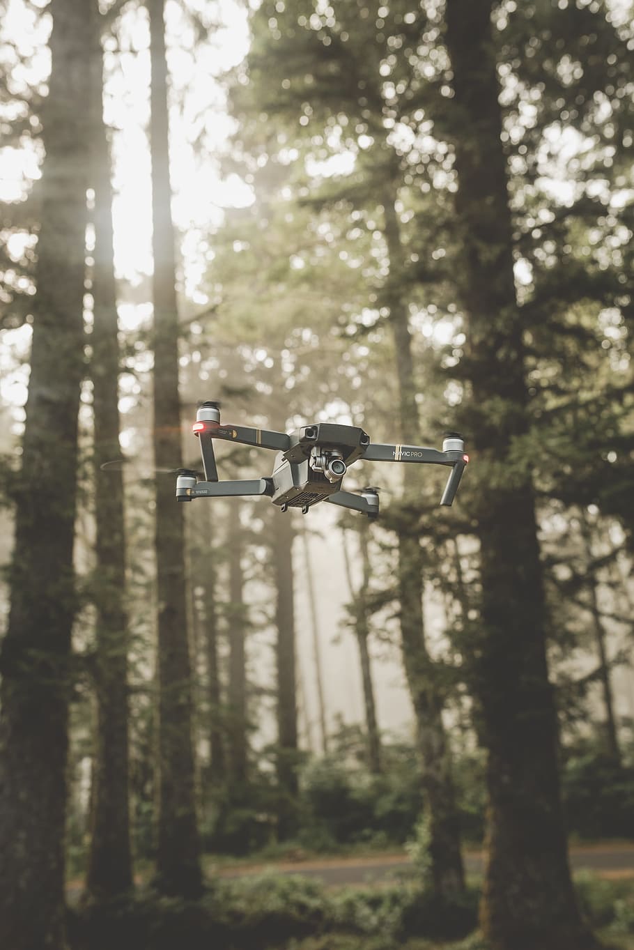 gray and black DJI Mavic Pro quadcopter drone on mid top air near forest at daytime HD wallpaper
