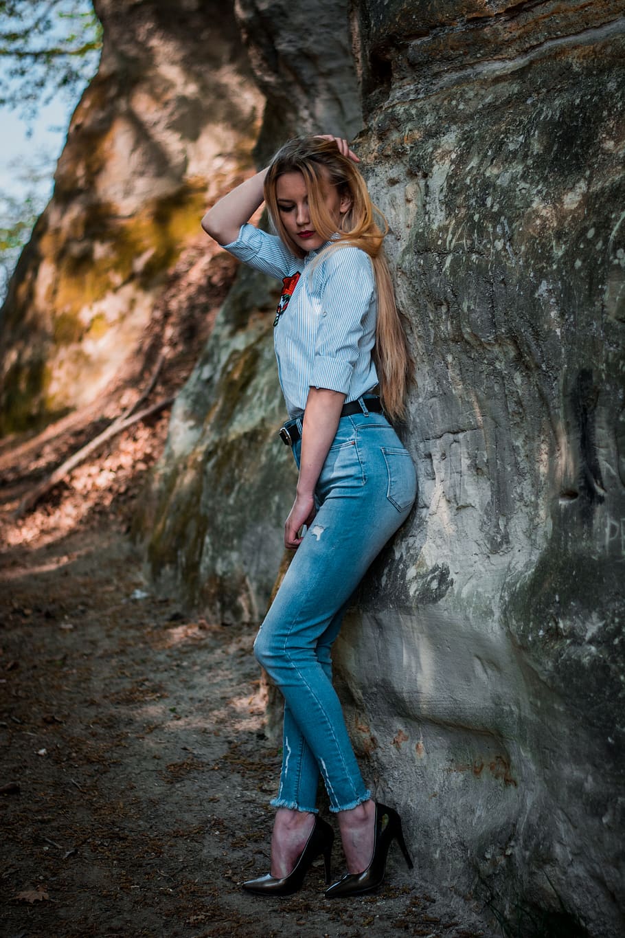 woman-leaning-on-gray-rock.jpg