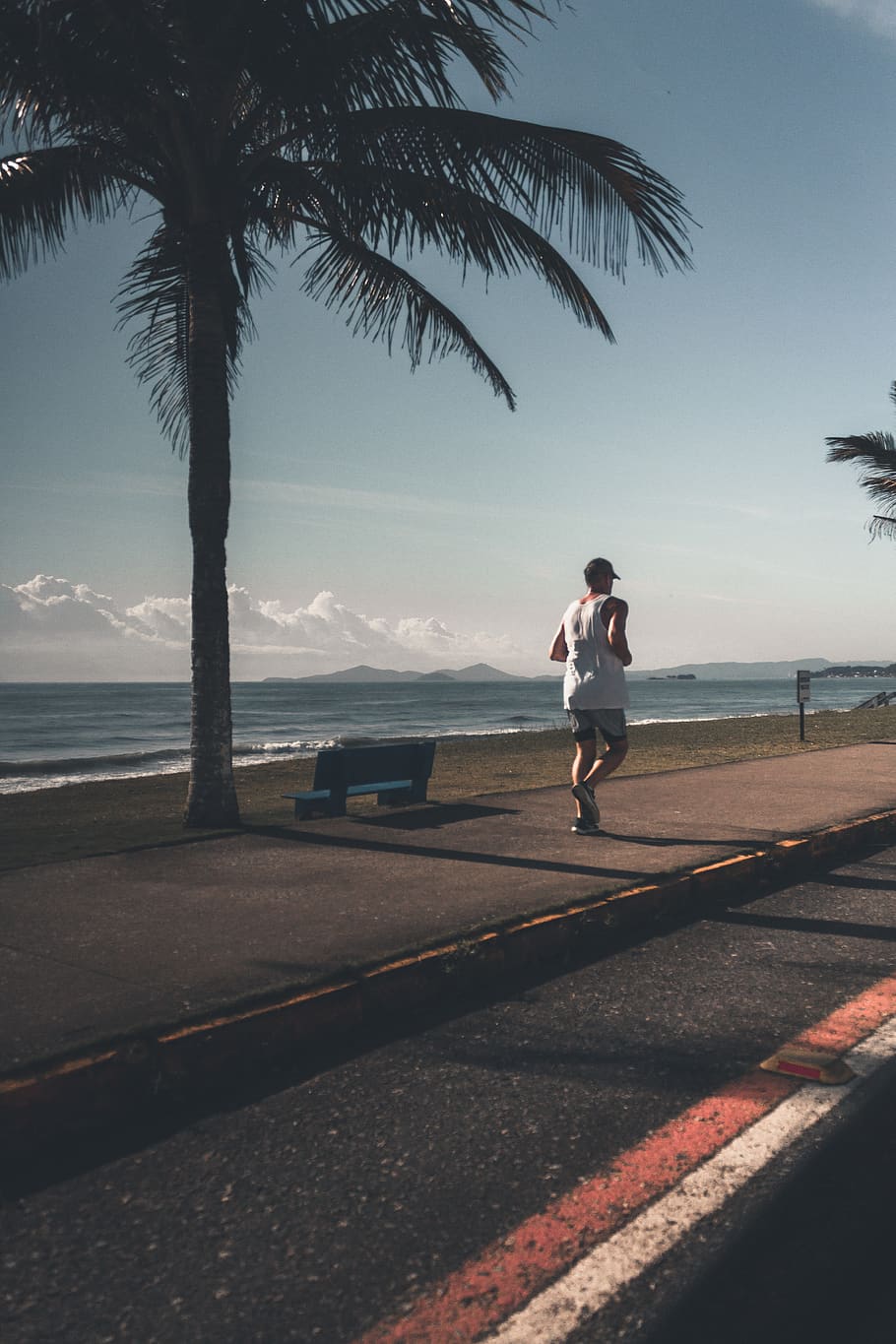 Man Wearing Tank Top Near Sea, beach, bench, cap, clouds, coast HD wallpaper