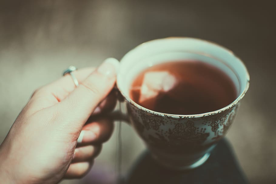 Person Holding Tea Cup, blurred background, close-up, drink, hand HD wallpaper