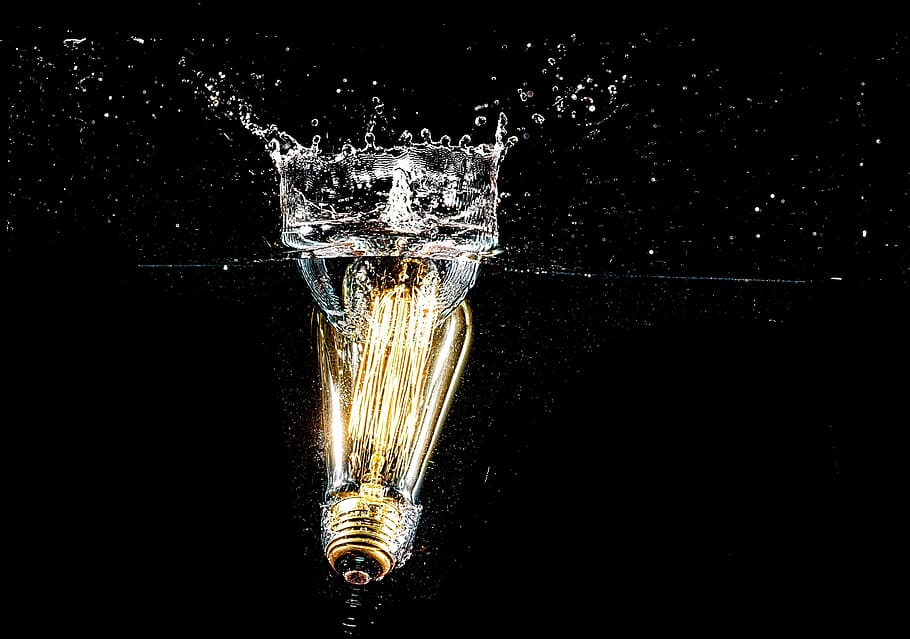 Photography of Light Bulb on Body of Water, black background HD wallpaper