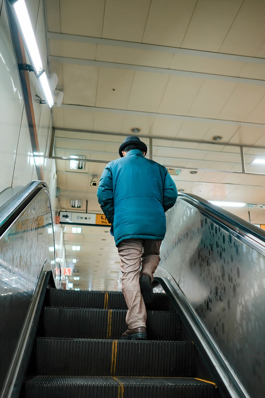 man in blue jacket going up escalator, handrail, banister, human HD wallpaper