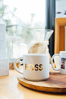white Boss-printed ceramic mug on brown surface, cup, coffee cup HD wallpaper