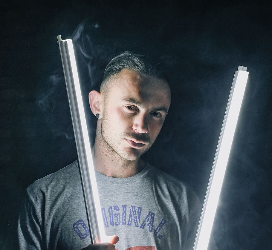 man holding lit fluorescents, one person, front view, portrait HD wallpaper