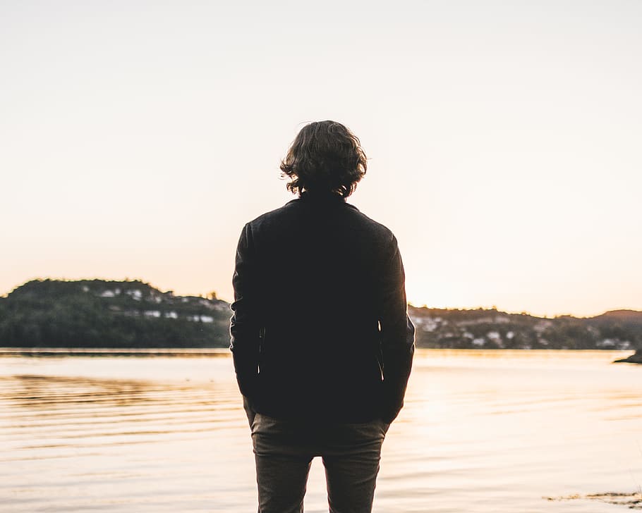 Man Standing Facing Body of Water, affection, backlit, beach HD wallpaper