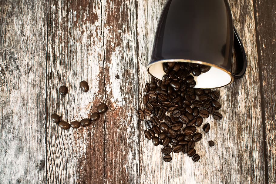 Black Ceramic Cup With Coffee Beans All on Brown Wooden Surface, HD wallpaper