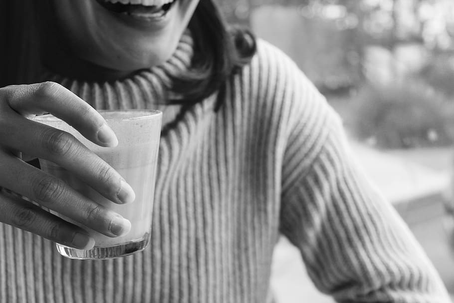 person holding cup smiling, one person, front view, focus on foreground HD wallpaper