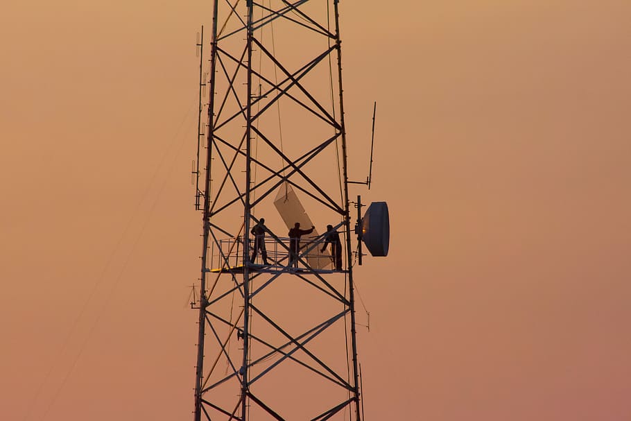 three people standing on crane tower, technology, sky, sunset HD wallpaper