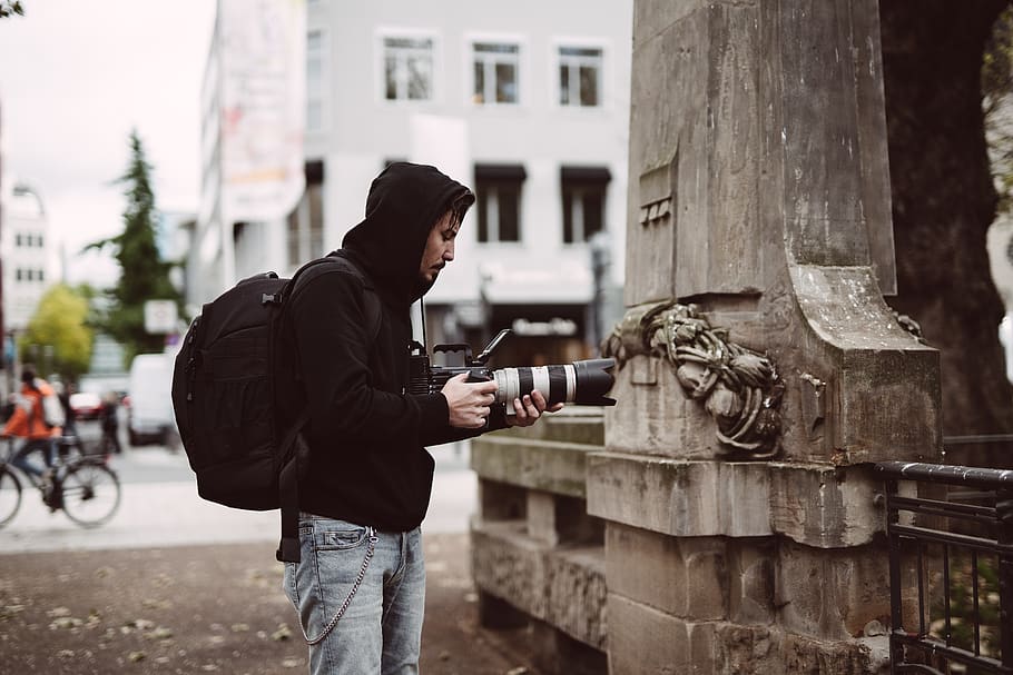 man holding black DSLR camera, one person, real people, three quarter length HD wallpaper