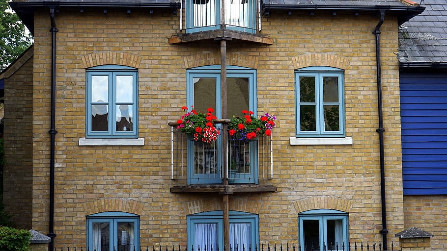 Flowers Hanged on Balcony Railing Near Windows, apartment, architecture HD wallpaper