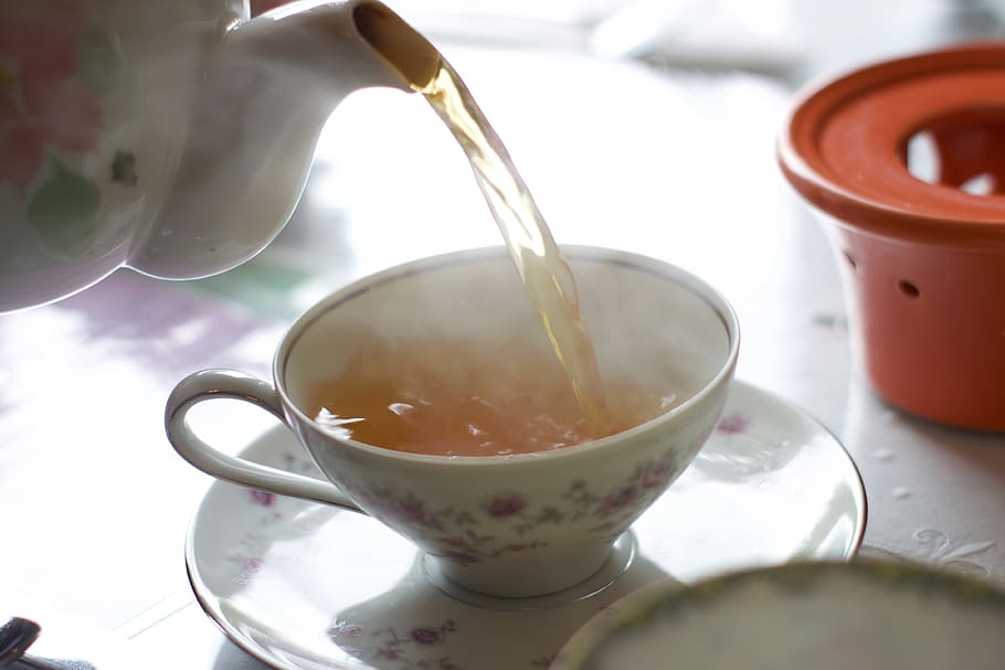 person pouring tea on white teacup, pottery, beverage, drink, HD wallpaper