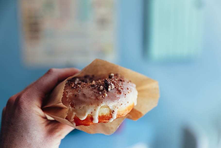 Person Holding Doughnut, blurred background, bread, close-up HD wallpaper