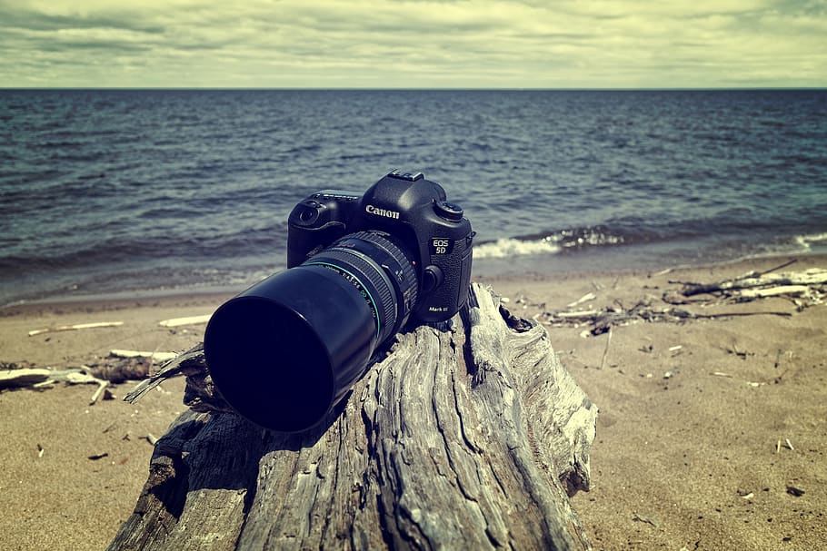Black Canon Dslr Camera Near Sea Shore, beach, clouds, daylight