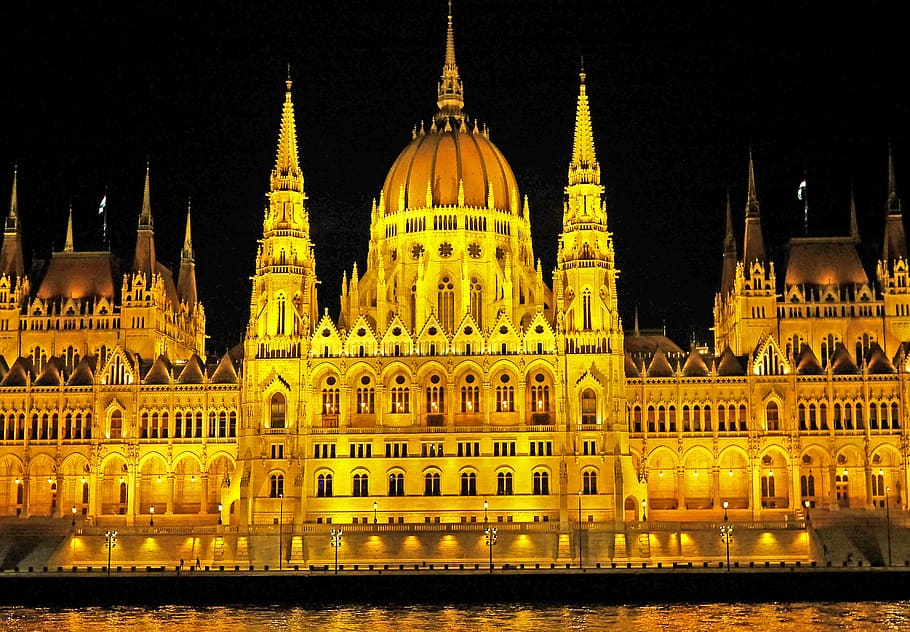 Light Concrete Building Near Body of Water during Night Time HD wallpaper