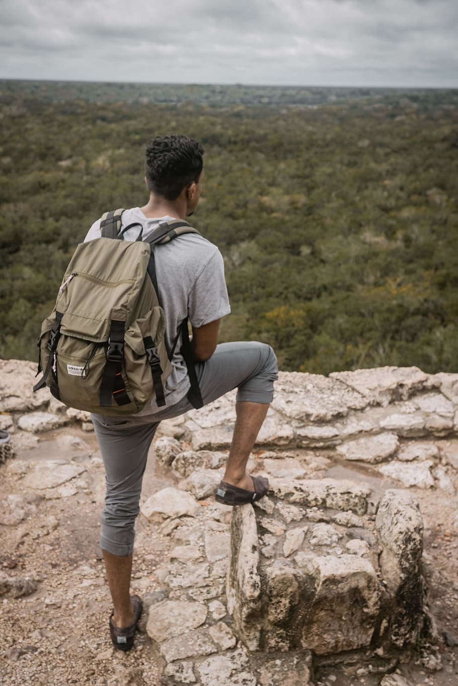 man with backpack standing on rock, rear view, one person, full length HD wallpaper
