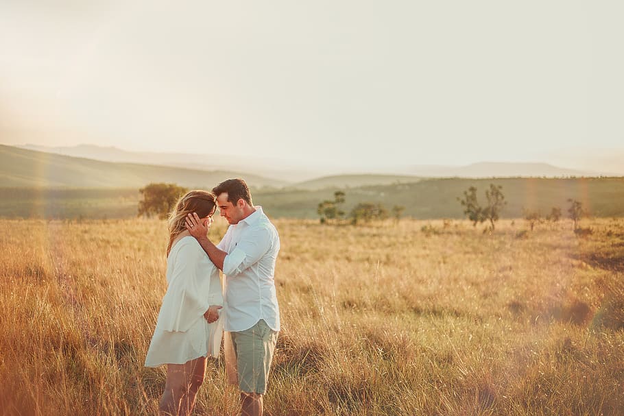 Man and Woman Standing Face to Face in Brown Grass Field, beautiful